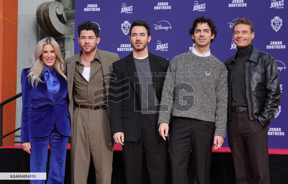 Jonas Brothers Hand And Footprint In Cement Ceremony - LA