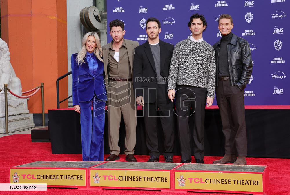 Jonas Brothers Hand And Footprint In Cement Ceremony - LA