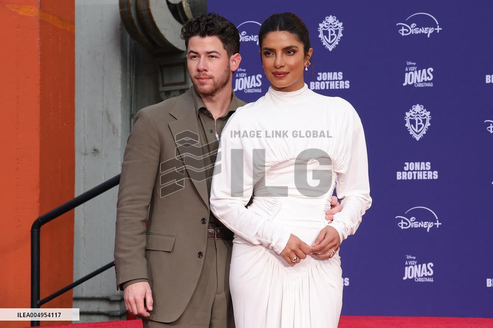 Jonas Brothers Hand And Footprint In Cement Ceremony - LA