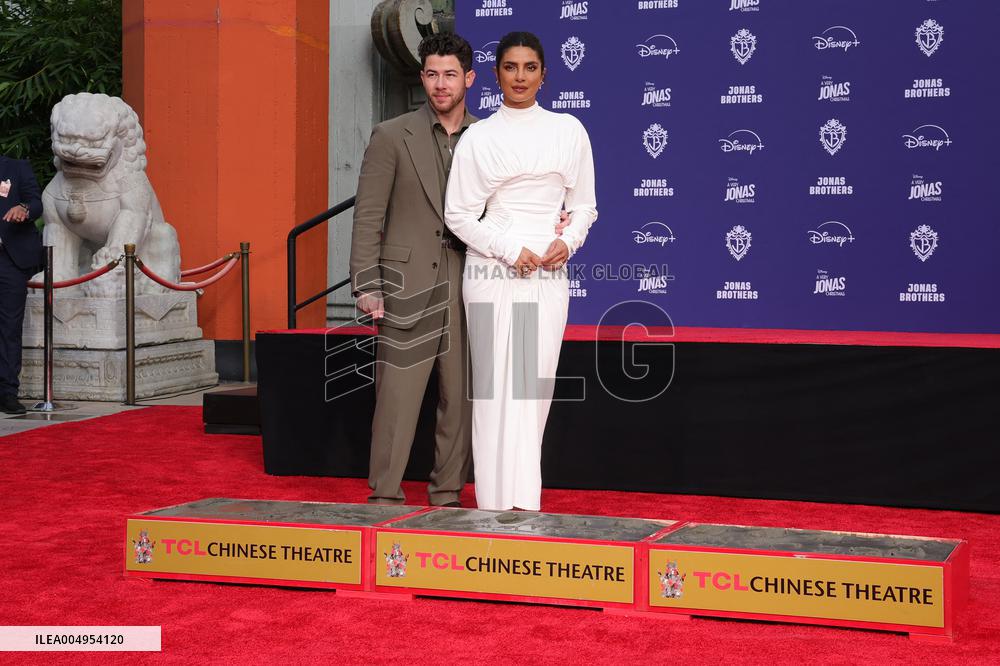 Jonas Brothers Hand And Footprint In Cement Ceremony - LA