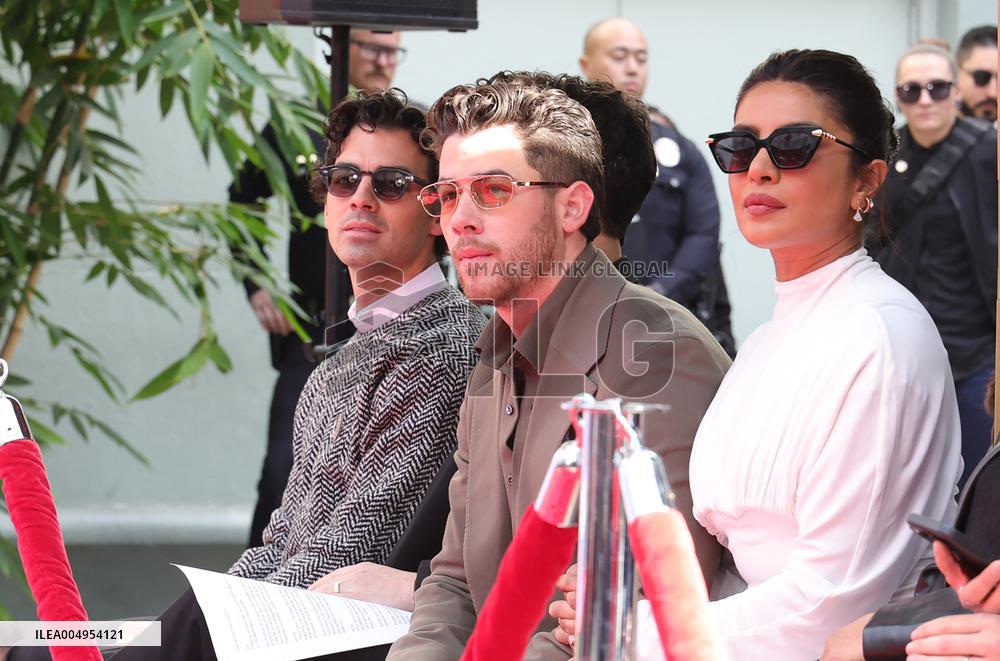 Jonas Brothers Hand And Footprint In Cement Ceremony - LA