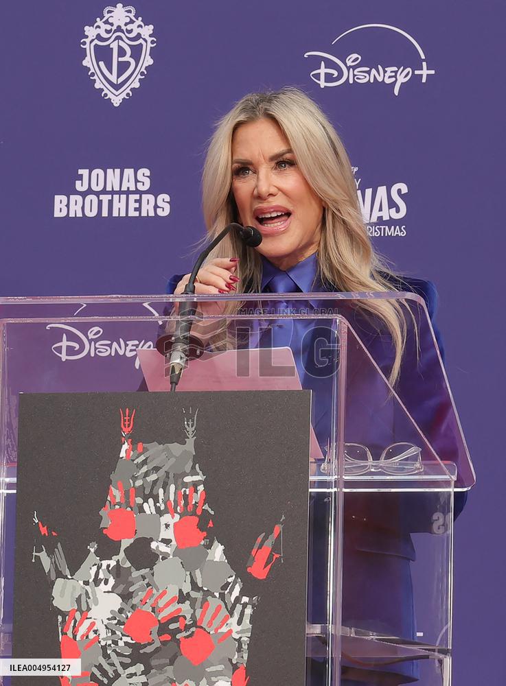 Jonas Brothers Hand And Footprint In Cement Ceremony - LA