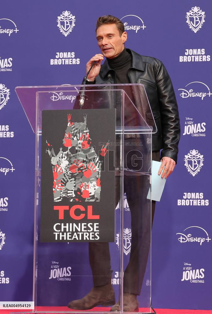 Jonas Brothers Hand And Footprint In Cement Ceremony - LA