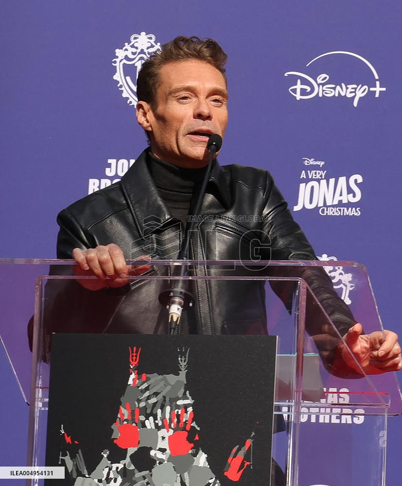 Jonas Brothers Hand And Footprint In Cement Ceremony - LA