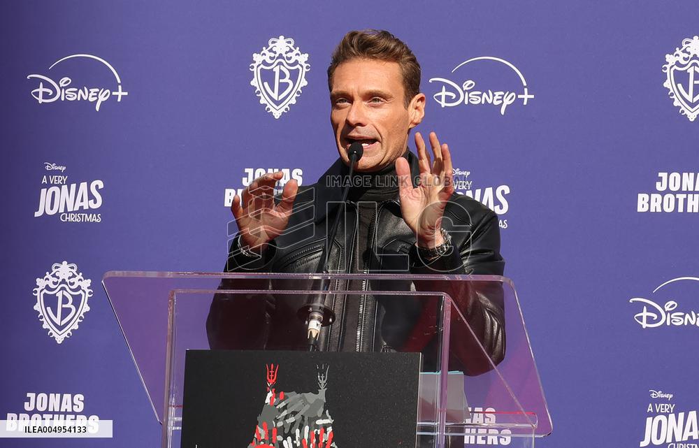 Jonas Brothers Hand And Footprint In Cement Ceremony - LA