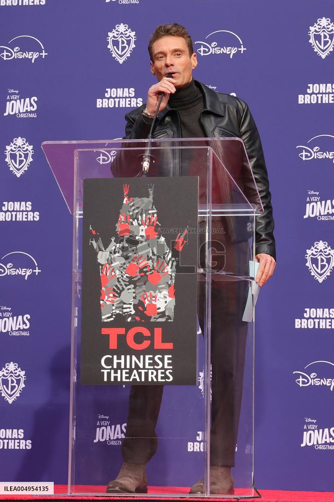 Jonas Brothers Hand And Footprint In Cement Ceremony - LA