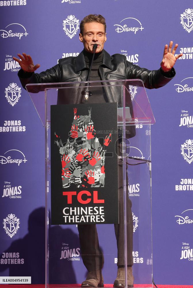 Jonas Brothers Hand And Footprint In Cement Ceremony - LA