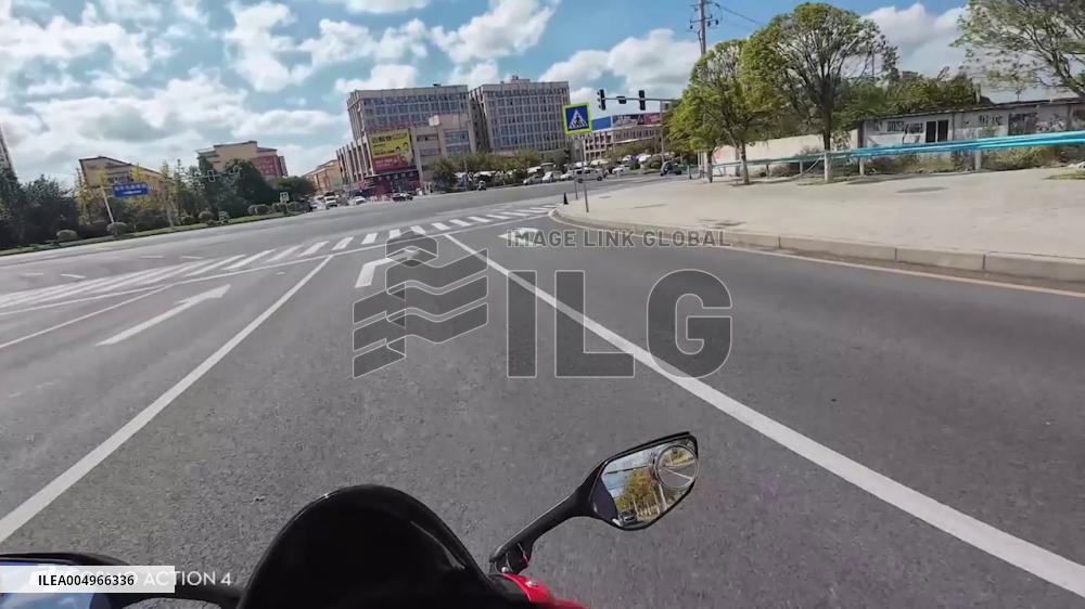 China: Video Shows Motorcyclist Hit by Car in Guizhou