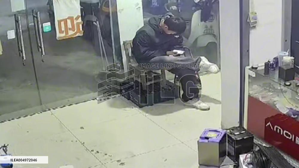 China: E-Bike Hits Storefront, Door Rebounds and Knocks Man Back