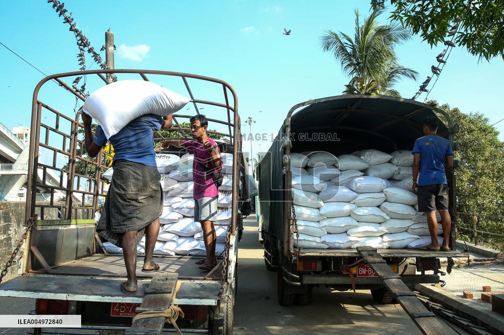 Workers Carry Bags of Rice - Myanmar