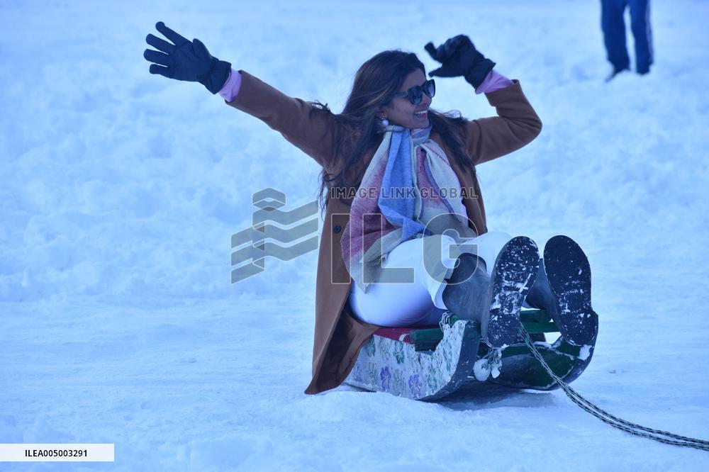 People Enjoy The Season's First Snowfall In Kashmir