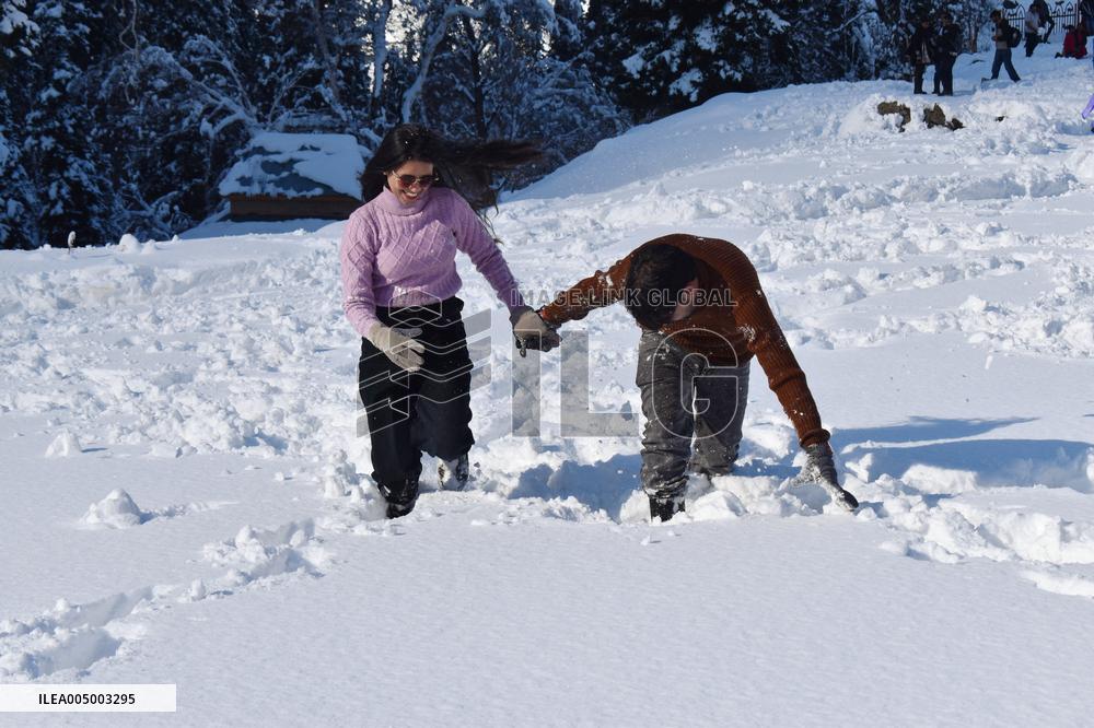 People Enjoy The Season's First Snowfall In Kashmir