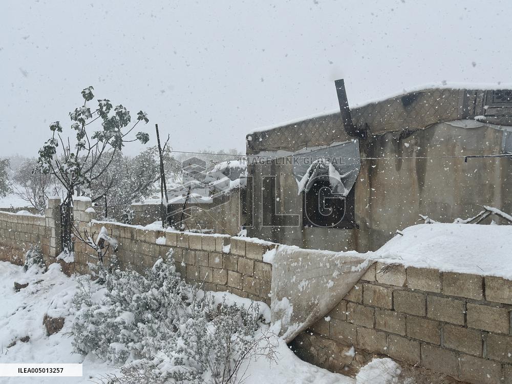 Snowstorms hit Syrian refugee camps.