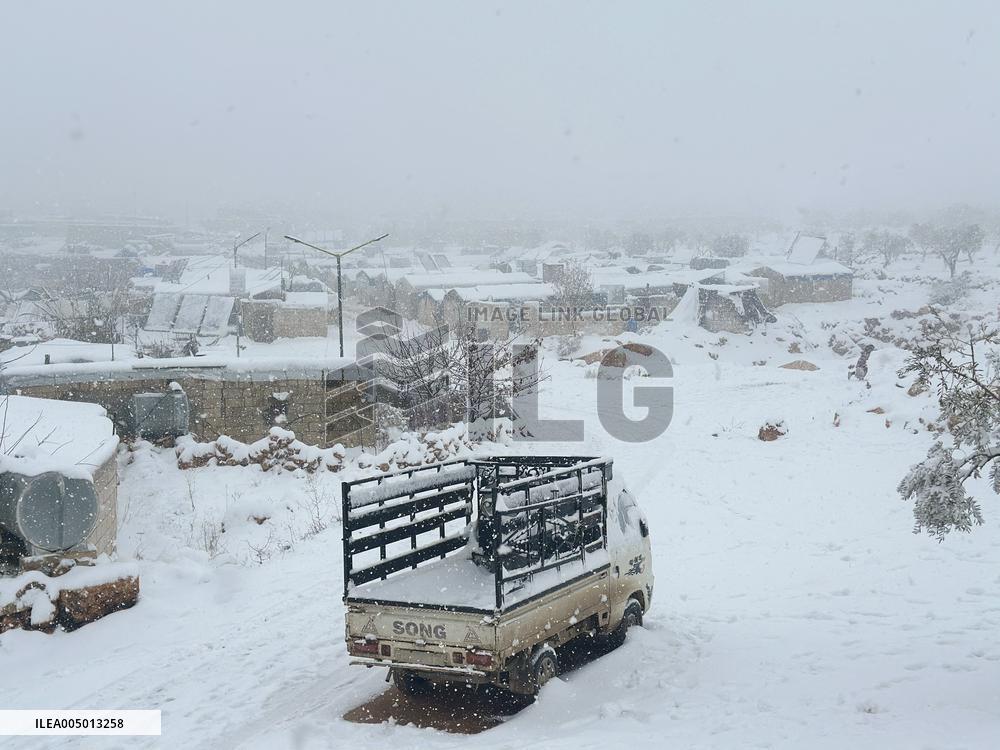 Snowstorms hit Syrian refugee camps.