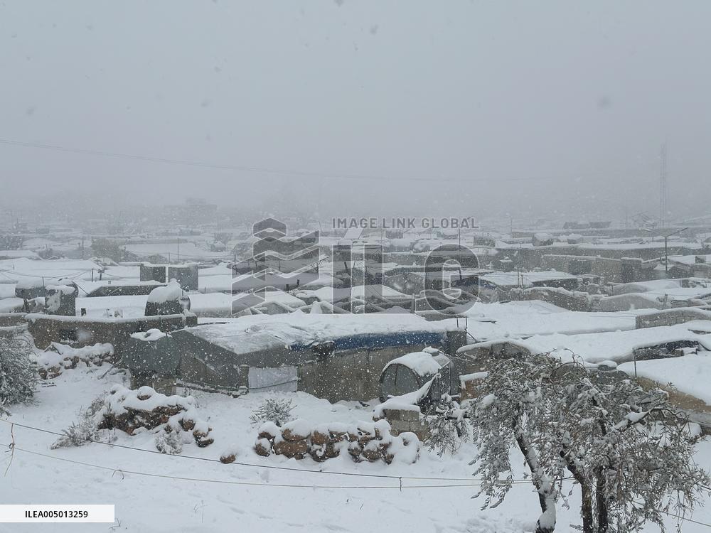 Snowstorms hit Syrian refugee camps.
