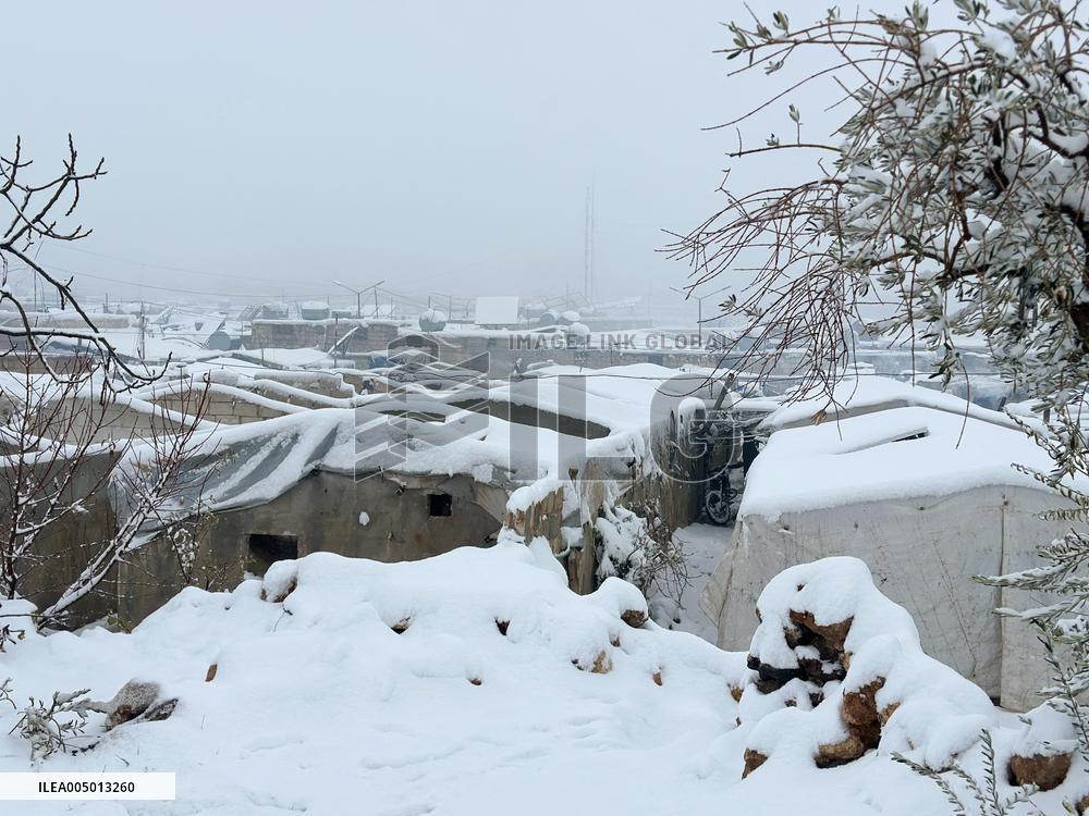 Snowstorms hit Syrian refugee camps.