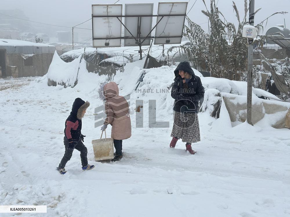 Snowstorms hit Syrian refugee camps.