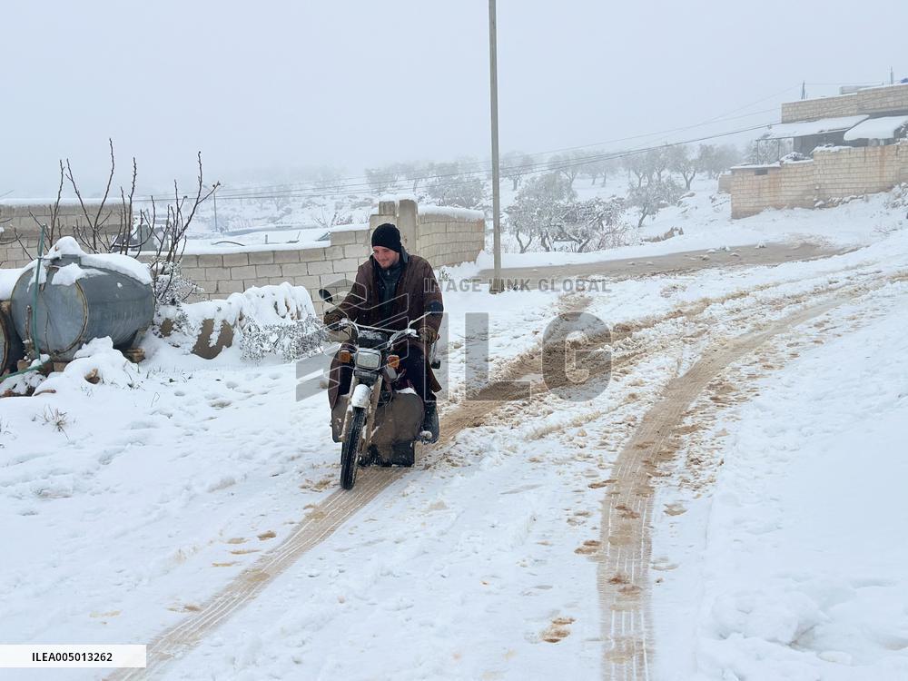 Snowstorms hit Syrian refugee camps.