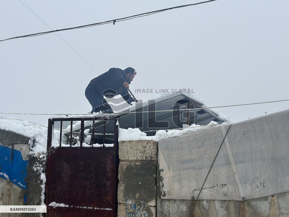 Snowstorms hit Syrian refugee camps.
