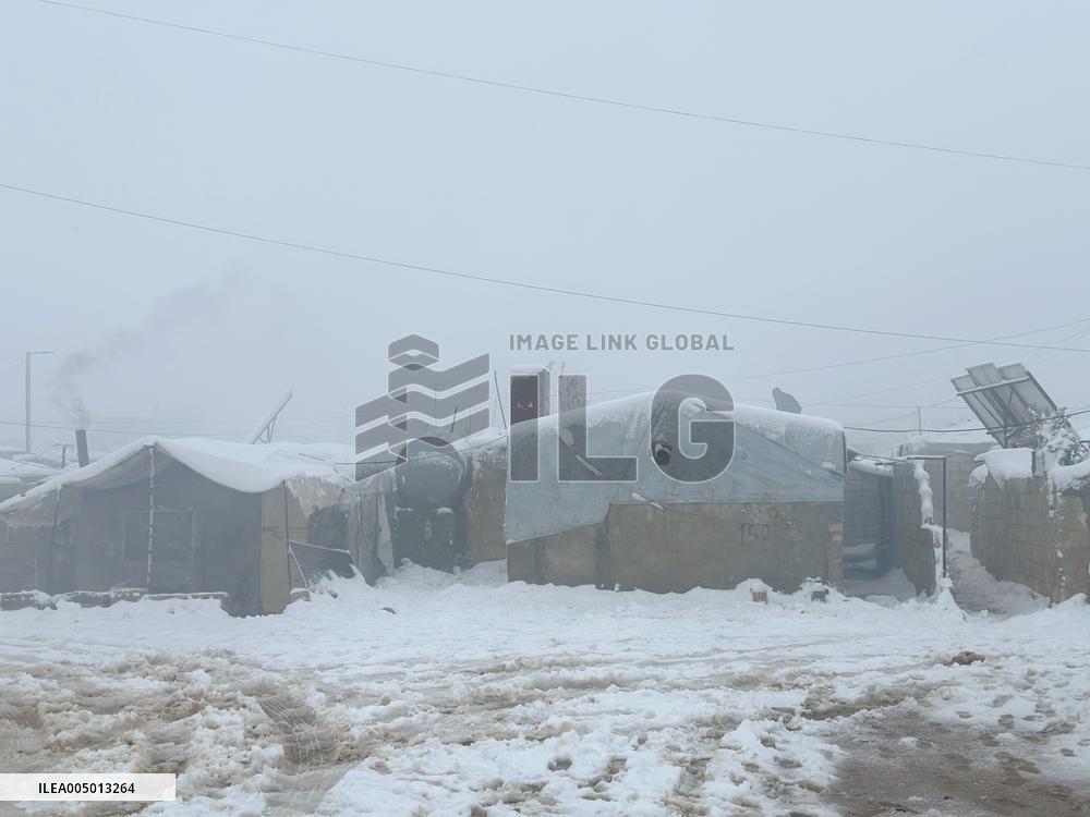 Snowstorms hit Syrian refugee camps.