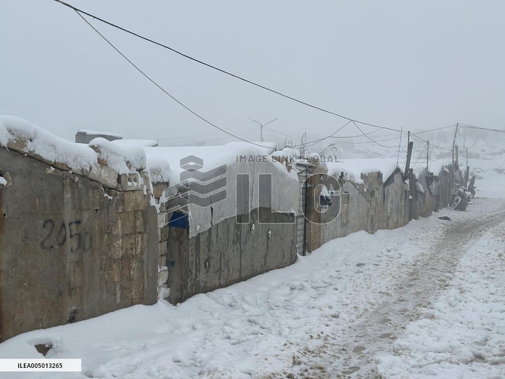 Snowstorms hit Syrian refugee camps.