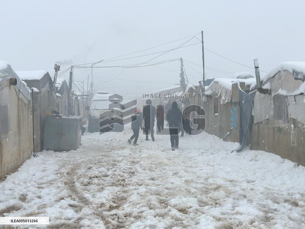 Snowstorms hit Syrian refugee camps.
