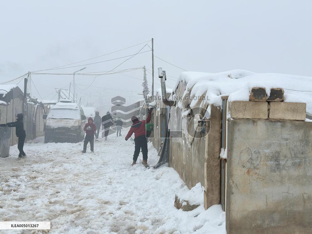 Snowstorms hit Syrian refugee camps.