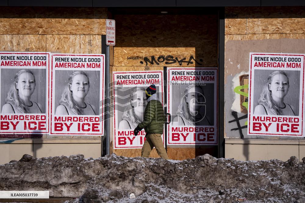 A Person Walks Past Signage For Renee Good - Minneapolis