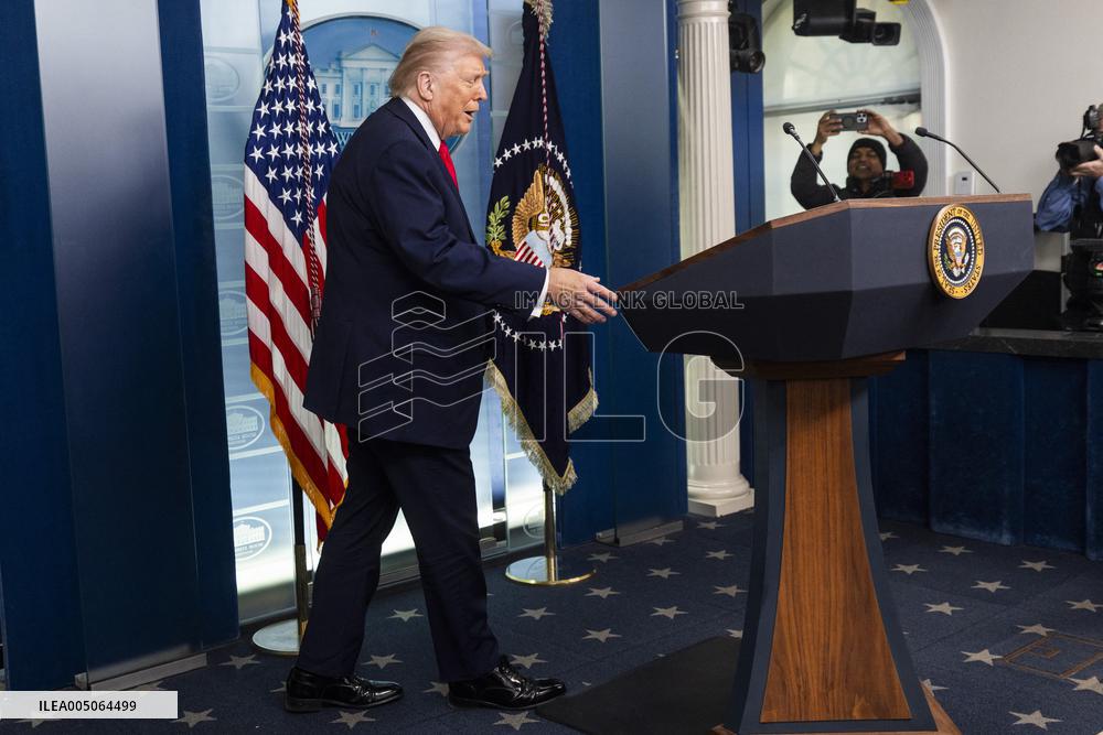 US President Trump speaks on to reporters ahead of trip to Davos