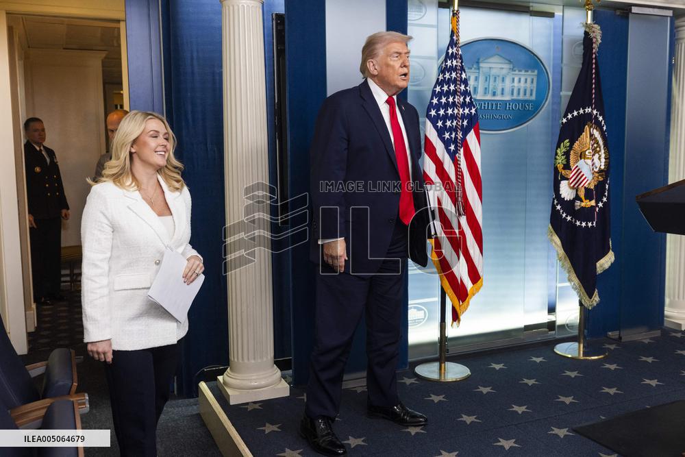 US President Trump speaks on to reporters ahead of trip to Davos