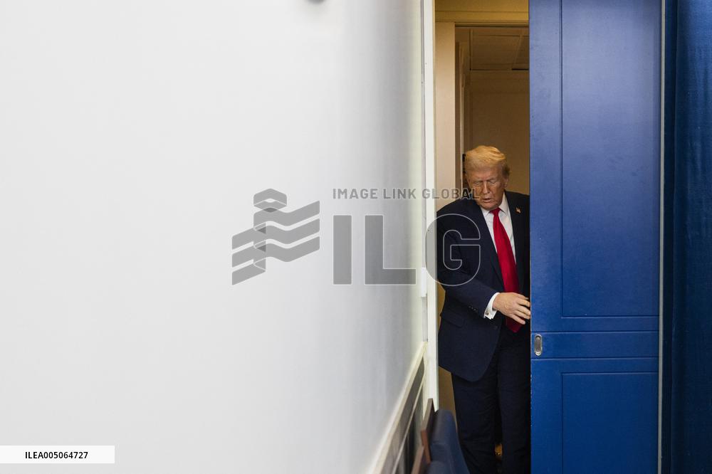 US President Trump speaks on to reporters ahead of trip to Davos