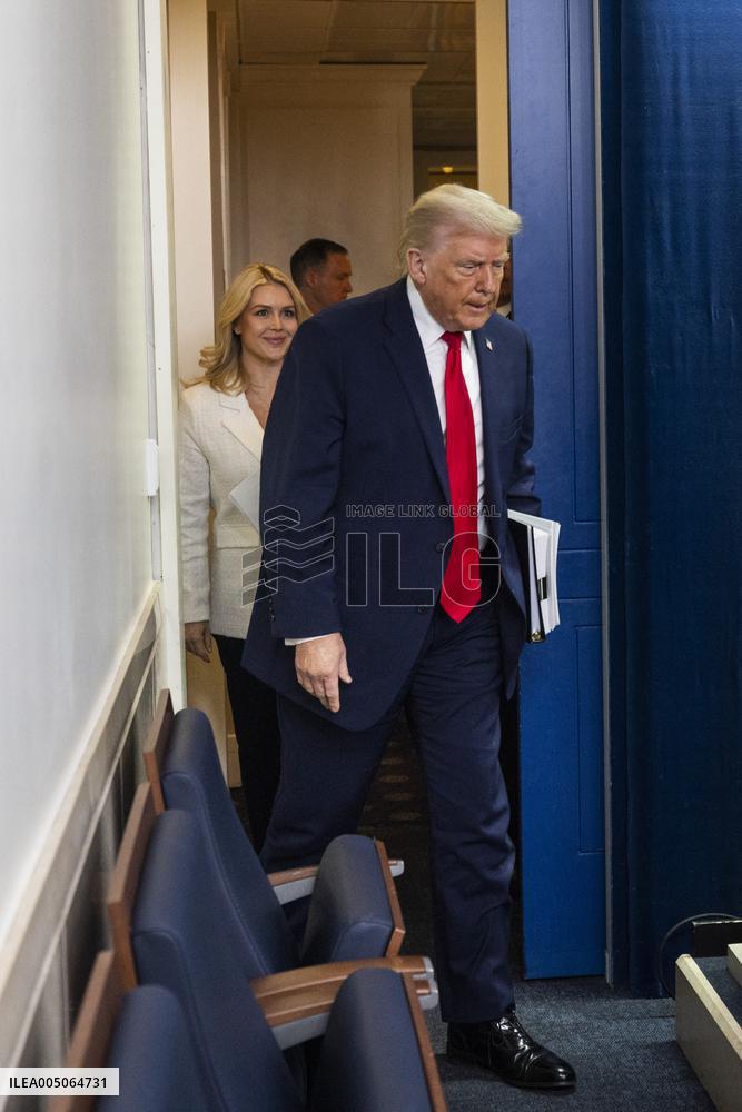 US President Trump speaks on to reporters ahead of trip to Davos