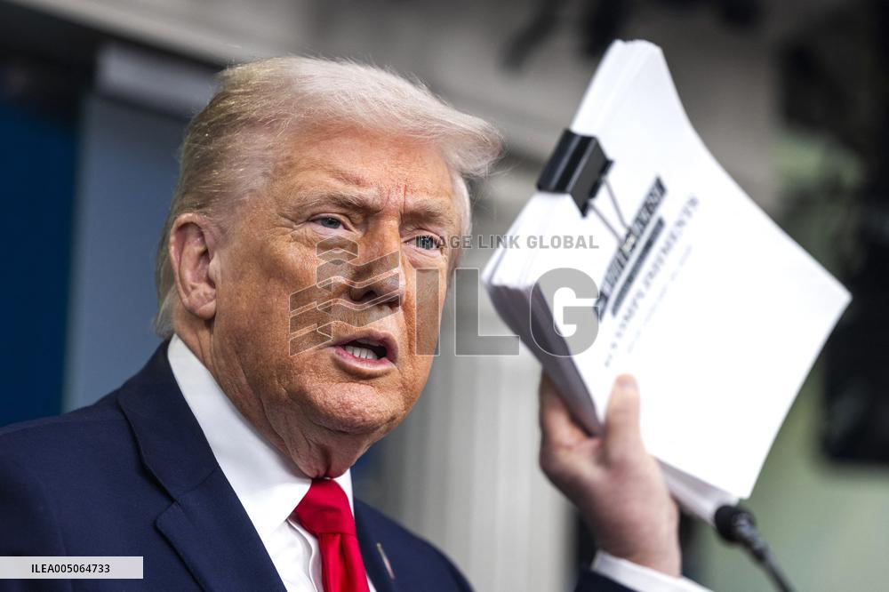 US President Trump speaks on to reporters ahead of trip to Davos