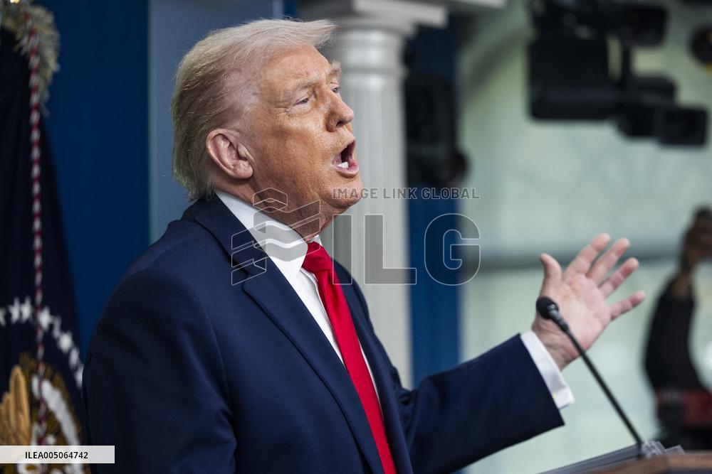 US President Trump speaks on to reporters ahead of trip to Davos