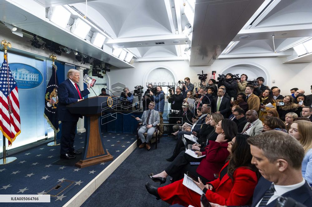 US President Trump speaks on to reporters ahead of trip to Davos