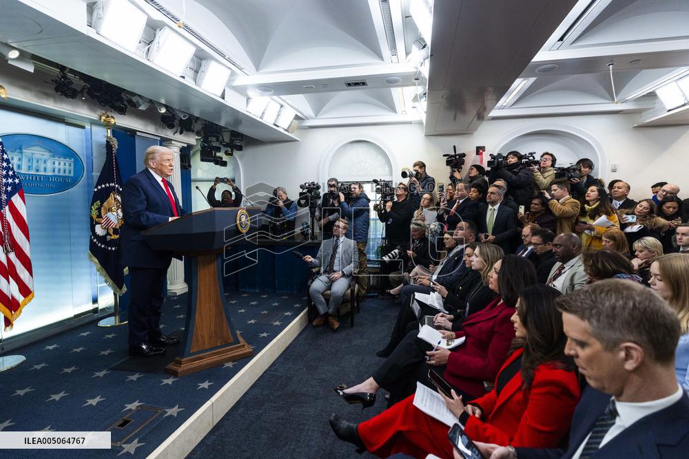 US President Trump speaks on to reporters ahead of trip to Davos