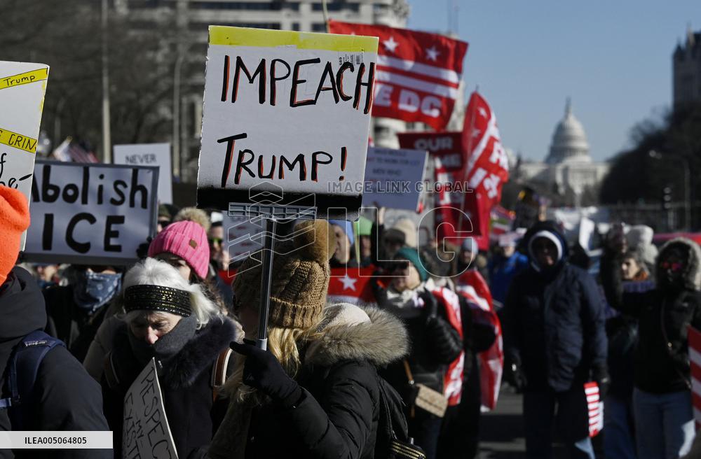 People protest on the first anniversary of President Donald Trump's second term in office