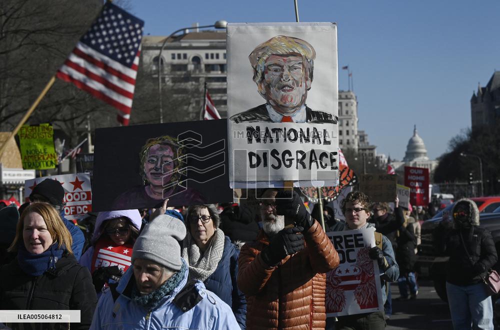 People protest on the first anniversary of President Donald Trump's second term in office