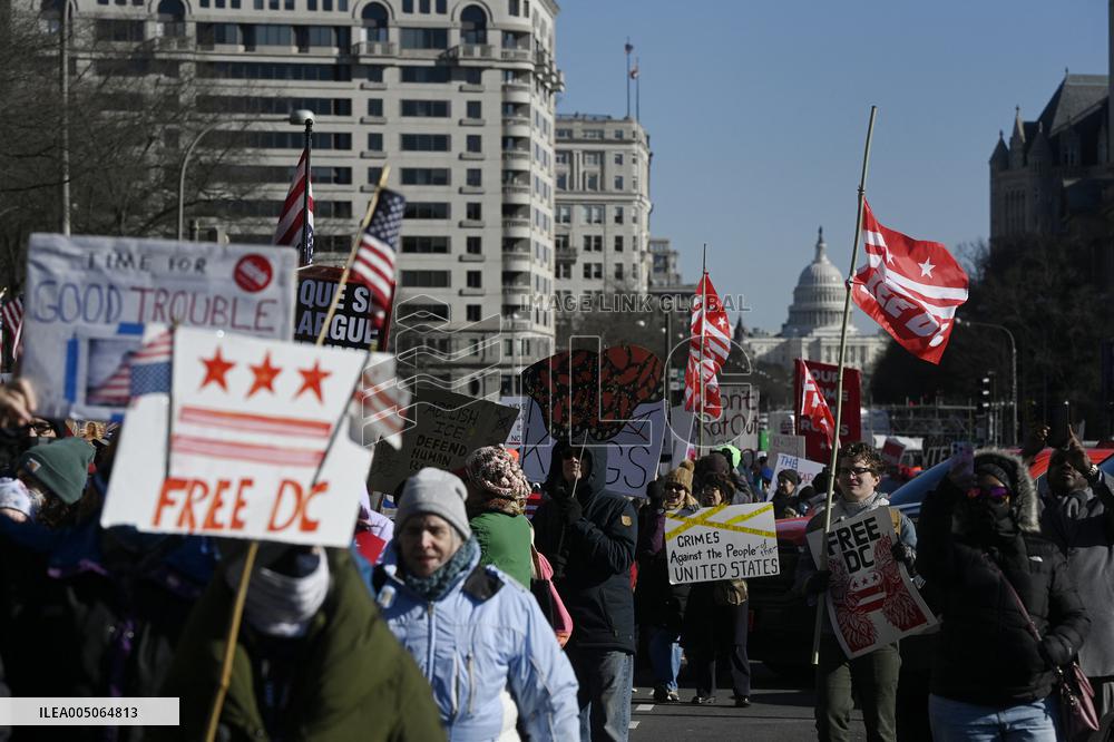 People protest on the first anniversary of President Donald Trump's second term in office