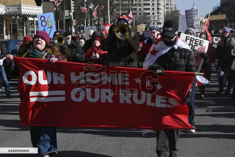 People protest on the first anniversary of President Donald Trump's second term in office