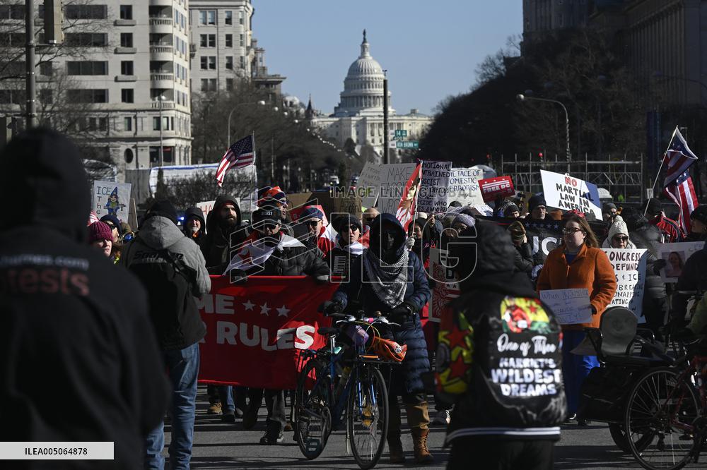 People protest on the first anniversary of President Donald Trump's second term in office