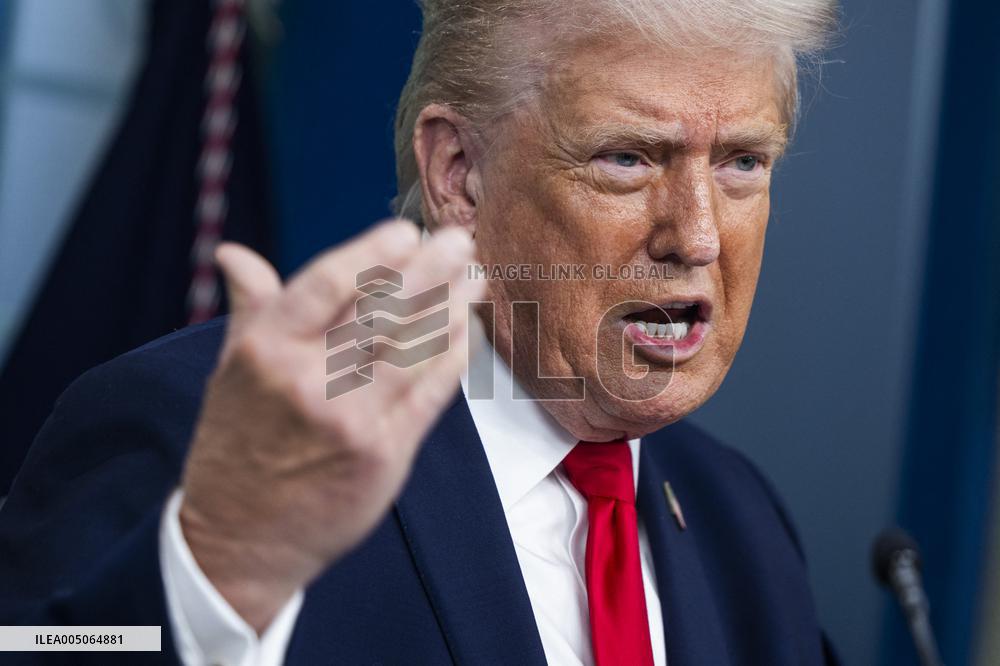 US President Trump speaks on to reporters ahead of trip to Davos