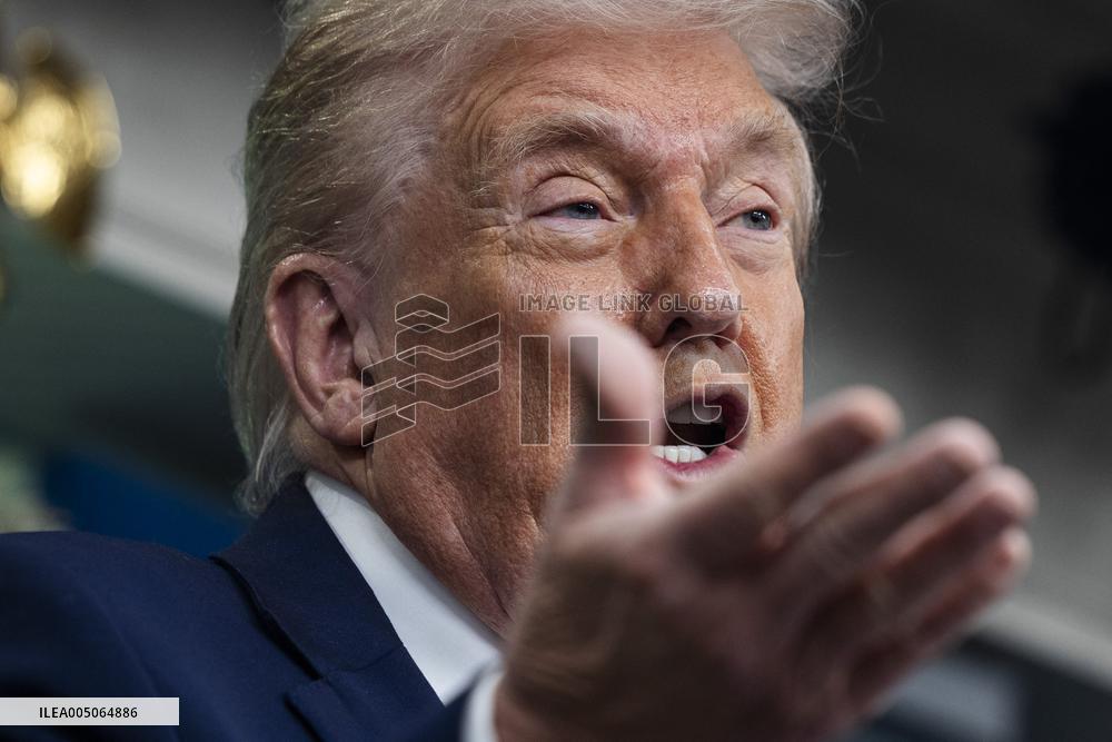 US President Trump speaks on to reporters ahead of trip to Davos