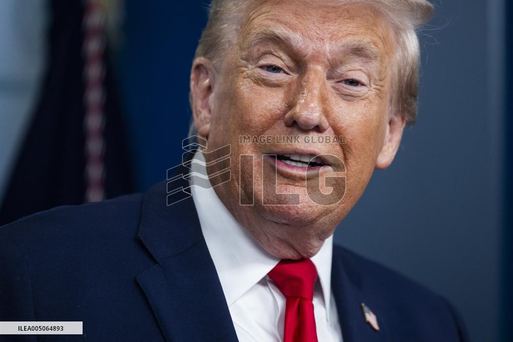 US President Trump speaks on to reporters ahead of trip to Davos