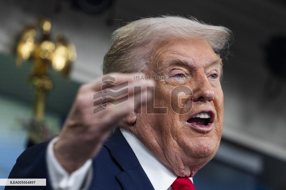 US President Trump speaks on to reporters ahead of trip to Davos