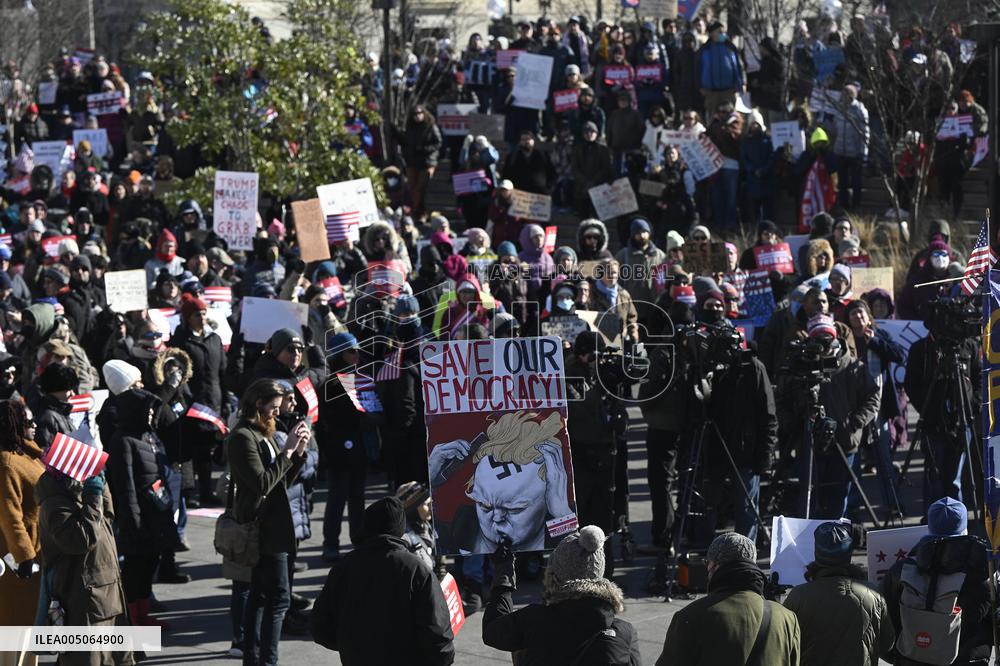 People protest on the first anniversary of President Donald Trump's second term in office