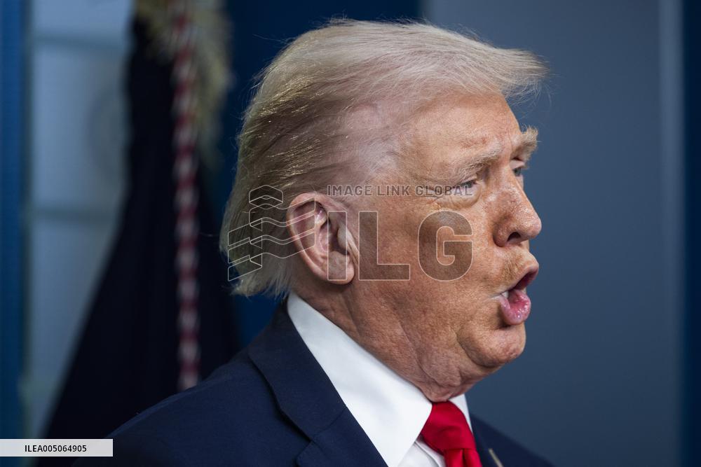 US President Trump speaks on to reporters ahead of trip to Davos