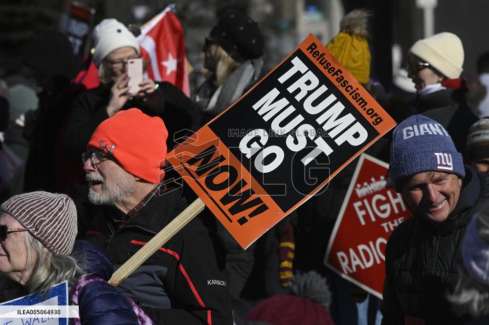 People protest on the first anniversary of President Donald Trump's second term in office