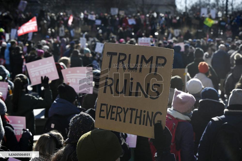 People protest on the first anniversary of President Donald Trump's second term in office