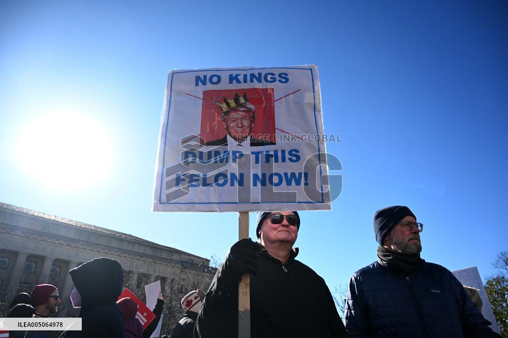 People protest on the first anniversary of President Donald Trump's second term in office